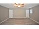 Large bonus room with ceiling fan and doors leading to other areas at 10922 Subtle Trail Dr, Riverview, FL 33579