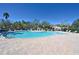 Freeform community pool with surrounding lounge chairs at 10922 Subtle Trail Dr, Riverview, FL 33579