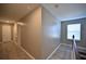 Light-toned hallway with laminate flooring and doors to other rooms at 10922 Subtle Trail Dr, Riverview, FL 33579