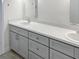 Double vanity bathroom with gray cabinets and white countertops at 2321 E Del Webb Blvd, Sun City Center, FL 33573