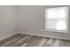 Well-lit bedroom with light gray walls and wood-look floors at 2321 E Del Webb Blvd, Sun City Center, FL 33573