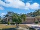 Single-story home with a two-car garage and palm trees at 2321 E Del Webb Blvd, Sun City Center, FL 33573