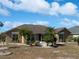 Single-story home with a screened patio and lush landscaping at 2321 E Del Webb Blvd, Sun City Center, FL 33573