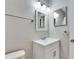 Bathroom with white vanity, modern lighting, and mirror at 27111 Wakefield Dr, Brooksville, FL 34602