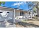 Newly renovated house with a white brick exterior and a covered porch at 27111 Wakefield Dr, Brooksville, FL 34602