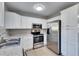 Modern kitchen with stainless steel appliances and white cabinets at 27111 Wakefield Dr, Brooksville, FL 34602