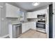 Modern kitchen with stainless steel appliances and white cabinets at 27111 Wakefield Dr, Brooksville, FL 34602