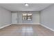 Living room with tile flooring and large window at 27111 Wakefield Dr, Brooksville, FL 34602