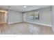 Living room with tile flooring, neutral walls, and hallway view at 27111 Wakefield Dr, Brooksville, FL 34602