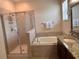 Bathroom with soaking tub, shower, and double vanity at 13642 Newport Shores Dr, Hudson, FL 34669