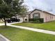 House exterior with driveway and front yard landscaping at 13642 Newport Shores Dr, Hudson, FL 34669