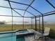 Enclosed pool and spa area overlooking a lake at 13642 Newport Shores Dr, Hudson, FL 34669