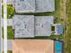 Top-down view of houses showcasing rooflines, landscaping, and a backyard patio with pergola at 3135 Great Banyan Way, Wesley Chapel, FL 33543