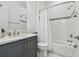 Clean bathroom boasts a white tub, gray vanity, and modern fixtures at 3135 Great Banyan Way, Wesley Chapel, FL 33543