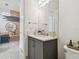 Modern bathroom with gray vanity, white countertop, and sleek mirror at 3135 Great Banyan Way, Wesley Chapel, FL 33543