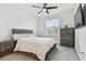 Bright bedroom with a queen bed and gray dresser at 3135 Great Banyan Way, Wesley Chapel, FL 33543