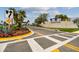 Landscaped entrance to the Winding Ridge community with palm trees and a gated entrance at 3135 Great Banyan Way, Wesley Chapel, FL 33543