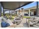 Modern patio featuring a fire pit, comfortable seating, and a pergola for shade at 3135 Great Banyan Way, Wesley Chapel, FL 33543