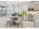 Kitchen nook with round table and chairs, near a vertical garden at 3135 Great Banyan Way, Wesley Chapel, FL 33543