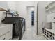 Bright laundry room with washer, dryer, and built-in storage at 3135 Great Banyan Way, Wesley Chapel, FL 33543