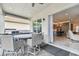 Covered patio with table and chairs, offering view of the kitchen at 3135 Great Banyan Way, Wesley Chapel, FL 33543