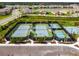 Aerial view of community tennis courts, pickleball courts, and a basketball court at 3135 Great Banyan Way, Wesley Chapel, FL 33543