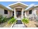 Inviting front entrance with covered porch and landscaping at 37337 Orange Row Ln, Dade City, FL 33525