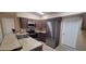 Modern kitchen with stainless steel appliances and tile countertops at 231 W Cornelius Cir, Sarasota, FL 34232