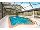 Inviting screened-in pool with brick coping and a spacious deck at 6154 Ashland Dr, Spring Hill, FL 34606