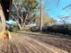Large backyard featuring a wood deck, mature trees, and a wooden fence at 802 Gateway Ln, Tampa, FL 33613