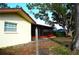 Backyard with screened porch, mature trees, and spacious yard at 802 Gateway Ln, Tampa, FL 33613