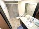 Bathroom featuring a shower with glass door, vanity, and tile flooring at 802 Gateway Ln, Tampa, FL 33613