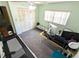 Spacious bedroom with carpeted floor, ceiling fan, and a desk and massage table at 802 Gateway Ln, Tampa, FL 33613