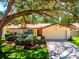 Ranch-style home with a two-car garage and well-manicured landscaping at 802 Gateway Ln, Tampa, FL 33613