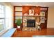 Stone fireplace with wood mantel and built-in shelving at 802 Gateway Ln, Tampa, FL 33613