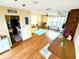 Open-concept living area featuring wood floors, a sofa, and a view into the kitchen at 802 Gateway Ln, Tampa, FL 33613