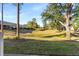 Backyard view with grassy area and trees at 18004 Tarrington Pl, Hudson, FL 34667