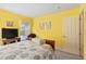 Bedroom with a queen-size bed and yellow walls at 18004 Tarrington Pl, Hudson, FL 34667