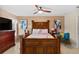 Main bedroom with a king-size bed and ceiling fan at 18004 Tarrington Pl, Hudson, FL 34667