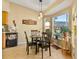 Bright breakfast nook features a table with four chairs and a view of the backyard at 18004 Tarrington Pl, Hudson, FL 34667