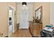 Bright entryway with wood floor and decorative console table at 18004 Tarrington Pl, Hudson, FL 34667