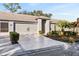 Front exterior view, showing driveway and landscaping at 18004 Tarrington Pl, Hudson, FL 34667