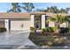 Brick front exterior of home with attached garage and landscaping at 18004 Tarrington Pl, Hudson, FL 34667