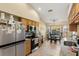 Open concept kitchen with stainless steel appliances and wood cabinets at 18004 Tarrington Pl, Hudson, FL 34667