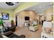 Spacious living room with vaulted ceilings, wood floors, and comfy furniture at 18004 Tarrington Pl, Hudson, FL 34667