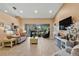 Living room with wood floors, large windows, and a view to backyard at 18004 Tarrington Pl, Hudson, FL 34667