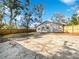 Large backyard with a spacious concrete patio and wooden fence at 3030 46Th W Ave, Bradenton, FL 34207