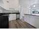 Modern kitchen with white cabinets, granite countertops, and stainless steel appliances at 3030 46Th W Ave, Bradenton, FL 34207