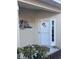 White front door decorated with hearts and tropical bird art at 3375 Osprey Ln, Port Charlotte, FL 33953
