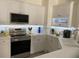 Modern white kitchen with stainless steel appliances at 3375 Osprey Ln, Port Charlotte, FL 33953